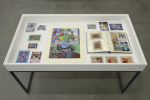 Vitrine with original artwork and reproductions